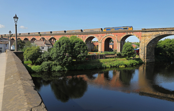 60087 heads over Yarm viaduct on 22.6.23 with a Drax to Tyne dock empty biomass.