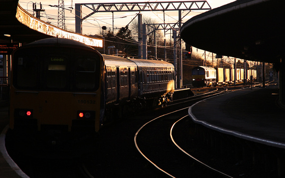 150132 waits at Carnforth for 66303 to pass for Coatbridge on 21.11.13.