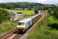 The DBS Management train heads past Keerholme with DVT 82146 leading and 67029 on the back.