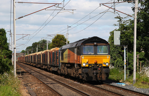 66847 heads past Bolton Le Sands with the Carlisle to Chirk logs.