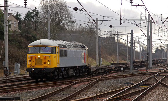 British & American Rail Services 56311 passes Carnforth with a Stoke to Motherwell wagon move.
