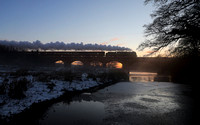 46115 heads over the River Lune at Arkholme as the sun sets and the mist lifts of the River on 11.12.22 with the ECS working from York to Carnforth.