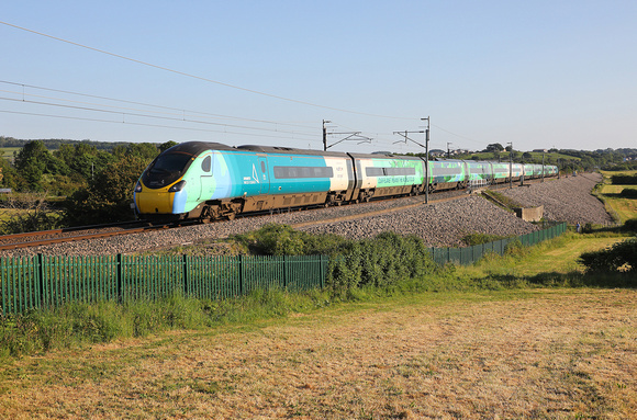 390121 heads away from Carnforth with a Glasgow service on 5.6.23.