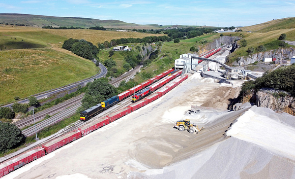 Dove Holes Quarry on 7.7.23. 20007 & 20205 have just coupled two wagons to the rake.66125 has its train loaded and 66744 waits to depart with the Hope service.