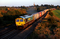 66589 passes Kings Sutton in the last rays of light with a Southampton to Trafford Park liner.