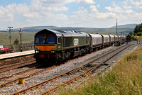 66779 heads past Ribblehead station with the Arcow to Bredbury stone service.