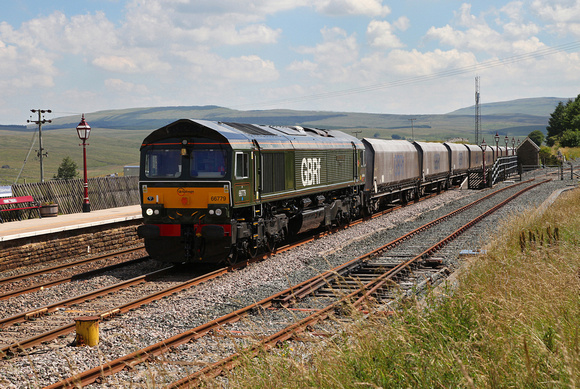 66779 heads past Ribblehead station with the Arcow to Bredbury stone service.