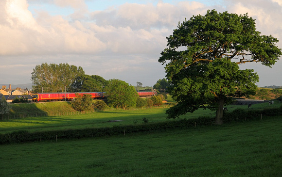 325s head away from Galgate at Oubeck with a Shieldmuir bound parcels train on 6.6.12