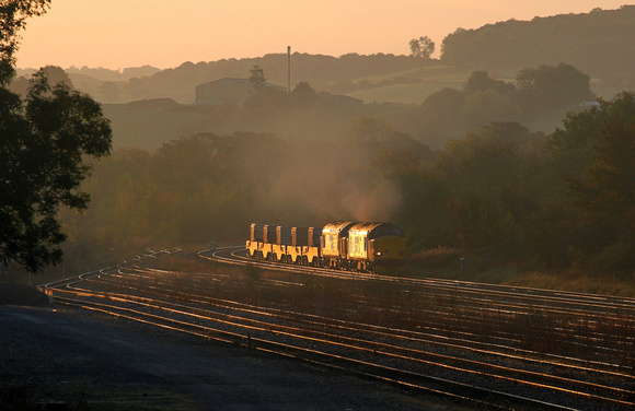 37218 & 37607 catch the first rays of light as they head away from Carnforth with 6C53.