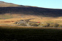 60011 dodges the shadows at Ribblehead on 9.12.22 with its Newbiggin to Tees Yard.