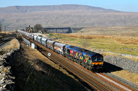 66718 heads past Ribblehead station with 6M37 11.25 Arcow Quarry to Pendleton.