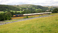 66733 heads towards Settle with the Mossend to Clitheroe cements on 17.7.19.