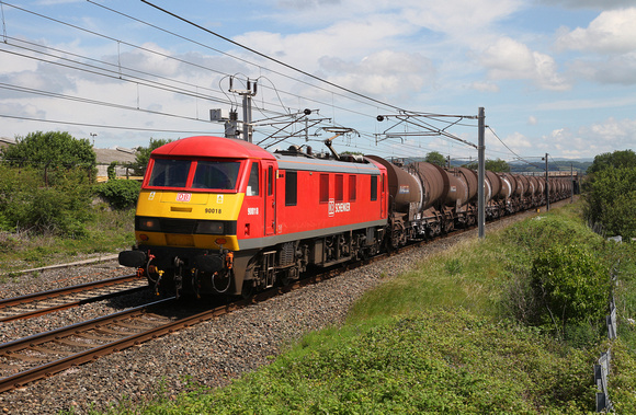 90018 passes Carnforth with a Mossend to Wembley train of empty china clays.