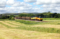 70801 heads away from Hellifield at Goosemere Heights with the Carlisle to Chirk logs.