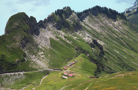 Two trains pass on the way to the top of the Brienz Rothorn Railway.