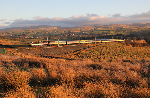 In the last of the days light, 87002 passes Greenholme with its Carlisle to Crewe test run.