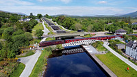 37669 heads over Banavie swing bridge with Neptunes stair case behind on the Caledonian Canal.