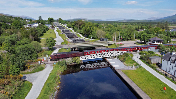 37669 heads over Banavie swing bridge with Neptunes stair case behind on the Caledonian Canal.