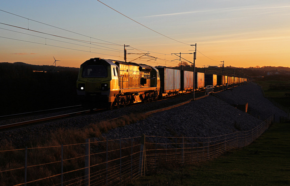 70011 heads away from Carnforth as the sun starts to set with 4S44 Daventry to Coatbridge on 4.1.17.