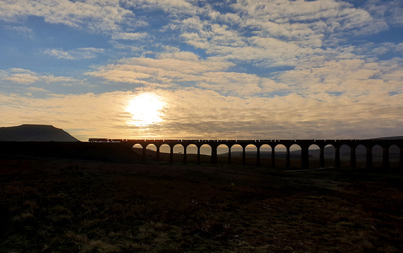 70807 heads over Ribblehead viaduct on 15.1.22 with the Carlisle to Chirk logs.