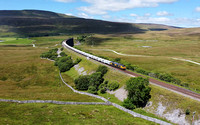 66784 heads away from Ribblehead viaduct on 7.7.22 with the Ribblehead to Hunslet stone service.