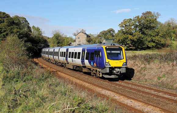 195117 passes Waterslack with a Manchester Airport service on 17.10.19