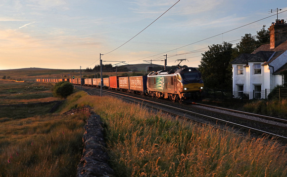 88006 drifts past Greenholme on 3.7.19 with the 18.54 Mossend Euroterminal to Daventry Tesco.