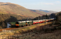 20096 and 20107 head through the Lune Gorge with the Preston to Carlisle leg of "The Seven Counties Rambler" on 8.3.25.