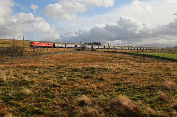 On hire from DBS, 92015 passes Scout Green on 1.11.13 with DRSs Tesco Express.